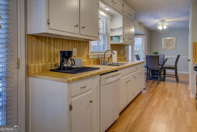 kitchen with dishwasher, light wood-type flooring, white cabinetry, and sink