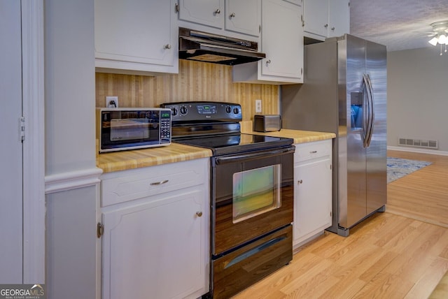 kitchen featuring black electric range, stainless steel refrigerator with ice dispenser, light hardwood / wood-style floors, and white cabinets