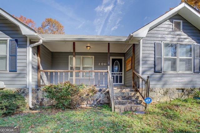 view of exterior entry with a porch