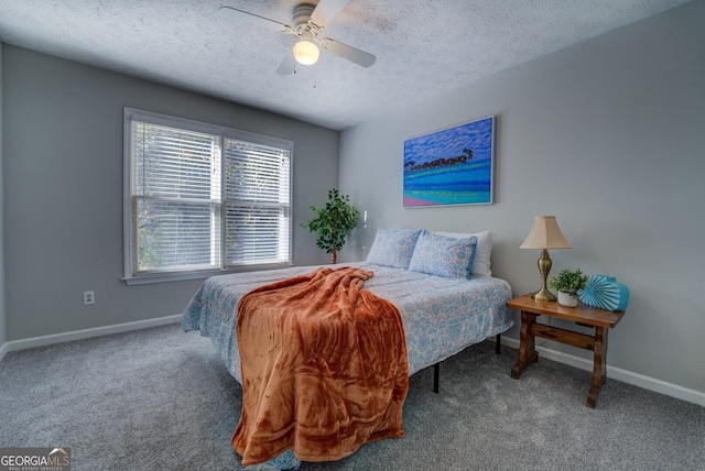 carpeted bedroom with a textured ceiling and ceiling fan