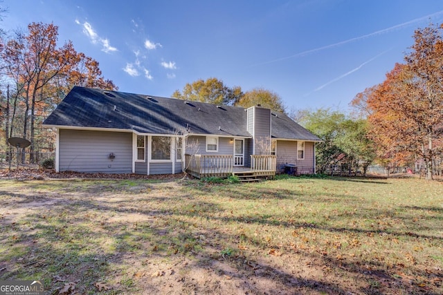 back of property featuring a lawn and a wooden deck