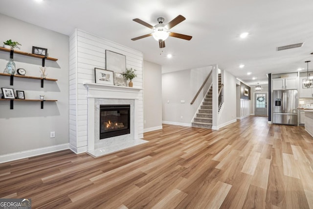 unfurnished living room with ceiling fan and light hardwood / wood-style floors