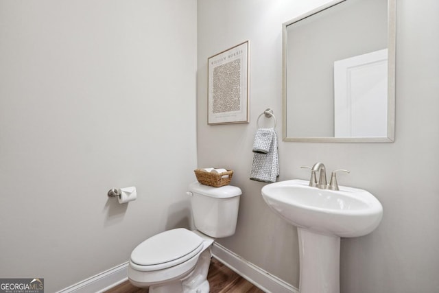 bathroom featuring sink, hardwood / wood-style floors, and toilet