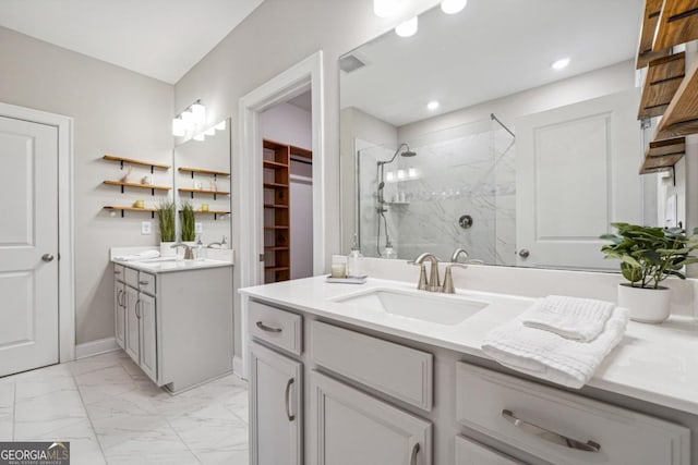 bathroom with vanity and a shower with door