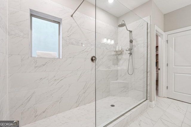 bathroom with tiled shower