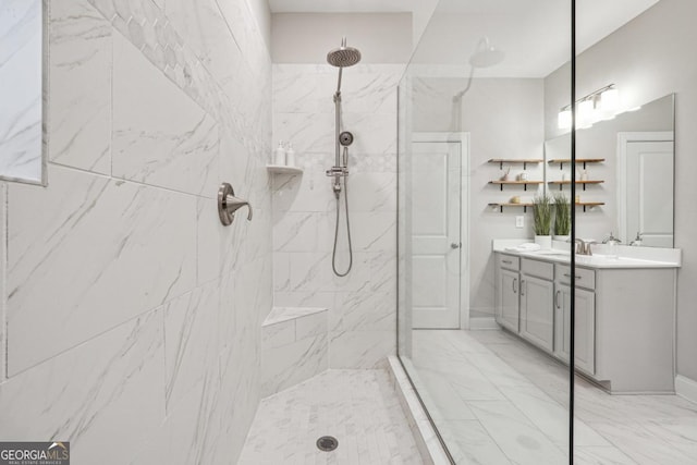 bathroom with a tile shower and vanity