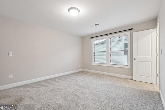 spare room with light colored carpet