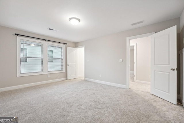 unfurnished bedroom with light carpet