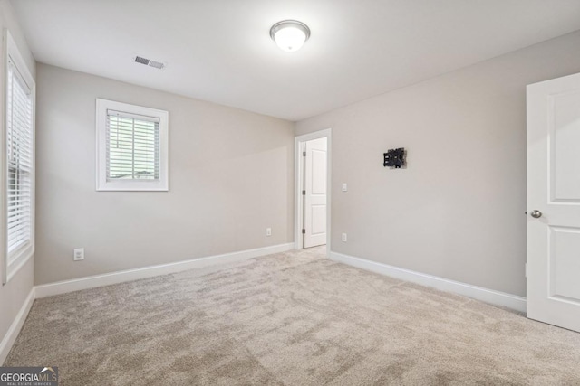 unfurnished room with light colored carpet