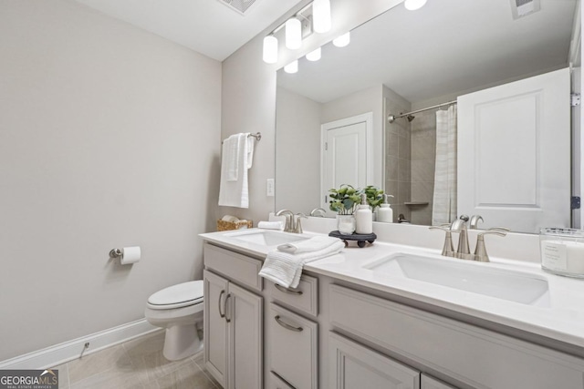 bathroom with tile patterned floors, a shower with curtain, vanity, and toilet