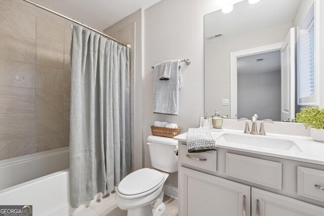 full bathroom featuring vanity, toilet, and shower / tub combo with curtain