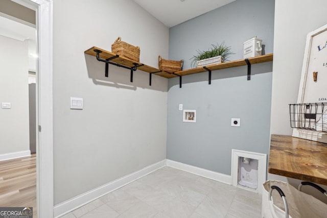 laundry room with electric dryer hookup, hookup for a washing machine, and light hardwood / wood-style flooring