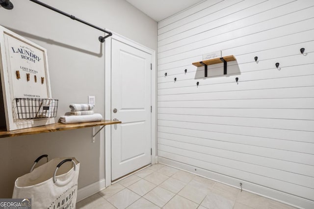 mudroom with wooden walls