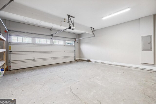 garage featuring electric panel and a garage door opener