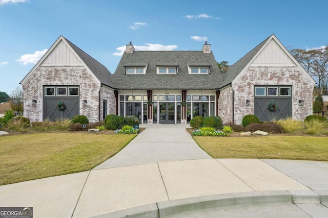 view of front of house with french doors and a front lawn