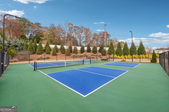 view of tennis court featuring basketball hoop