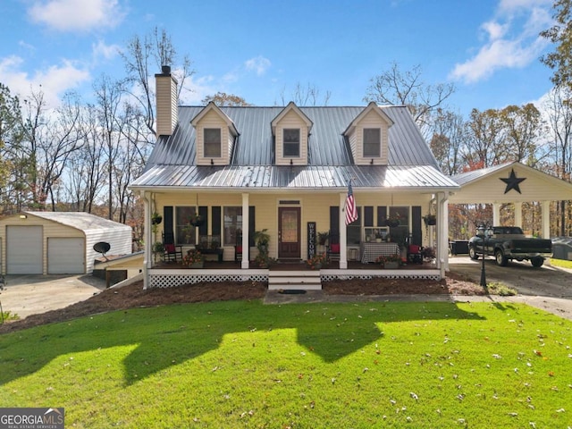 view of front facade with a front yard, a garage, an outdoor structure, and covered porch