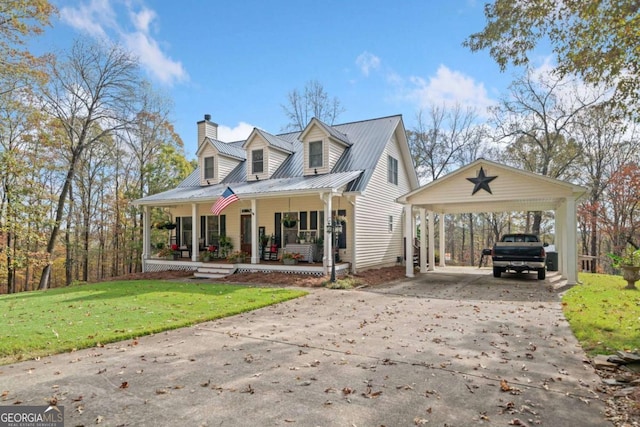 new england style home with a front lawn, covered porch, and a carport