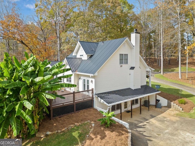 view of property exterior with a deck