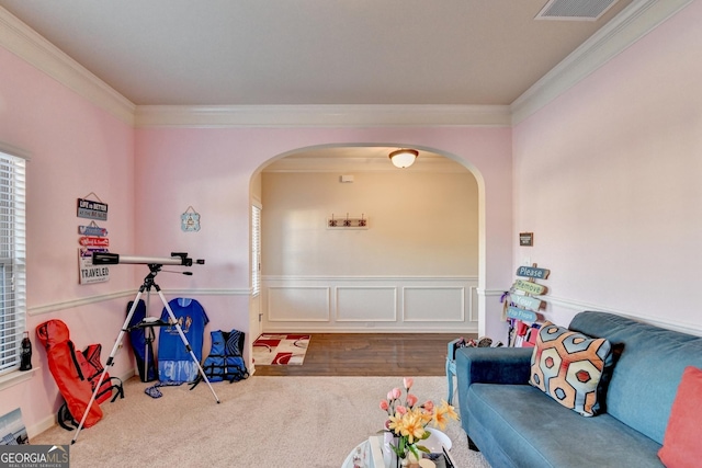 recreation room with hardwood / wood-style floors and crown molding