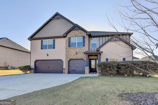 view of front facade featuring central AC, a front yard, and a garage