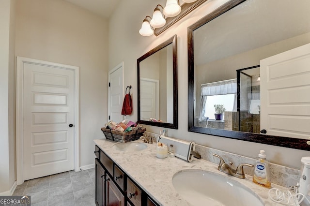 bathroom featuring tile patterned flooring, vanity, and walk in shower