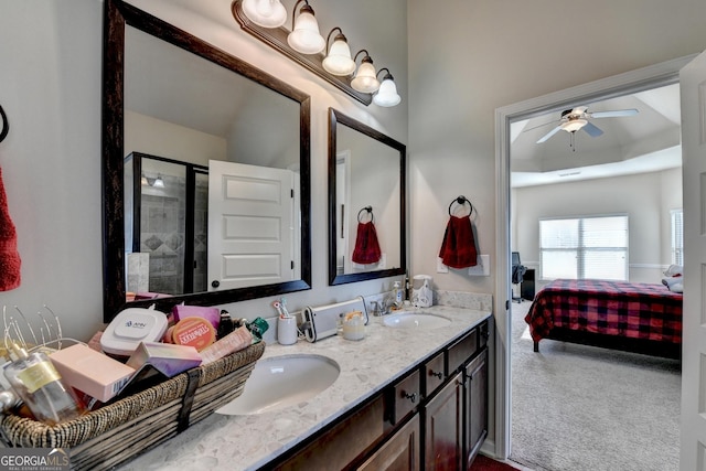 bathroom with vanity, a shower with door, and ceiling fan