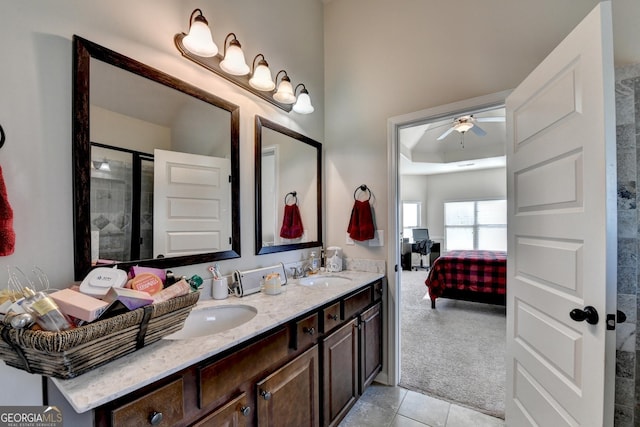 bathroom featuring tile patterned floors, vanity, and a shower with shower door