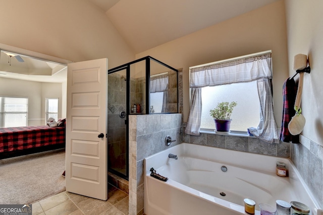 bathroom featuring separate shower and tub, tile patterned floors, and lofted ceiling