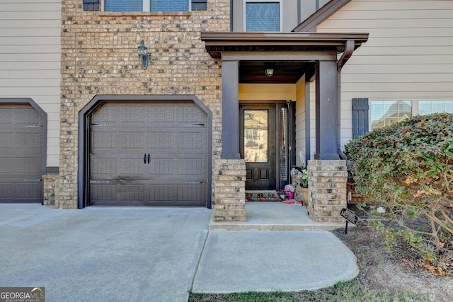 doorway to property with a garage