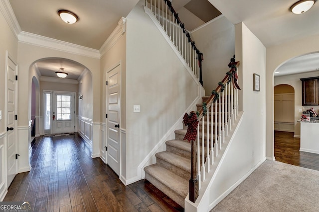 entrance foyer featuring ornamental molding and dark wood-type flooring