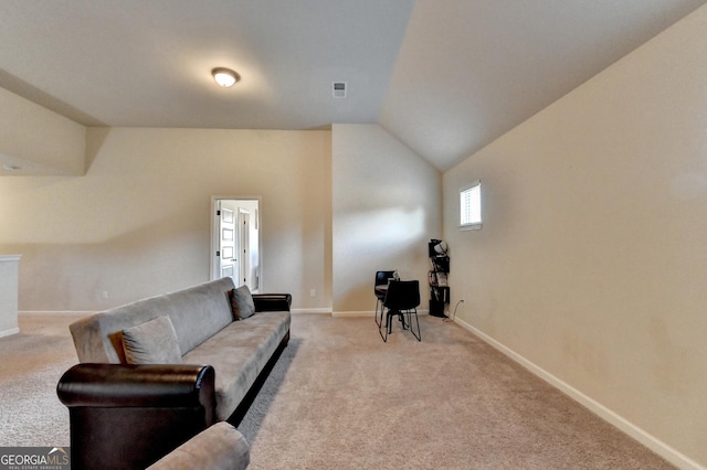 carpeted living room featuring lofted ceiling