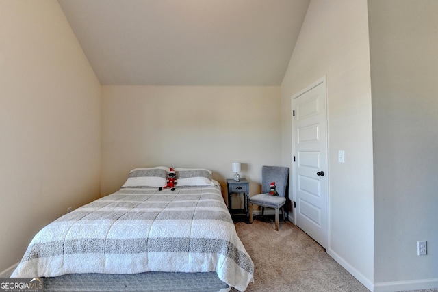 carpeted bedroom with vaulted ceiling