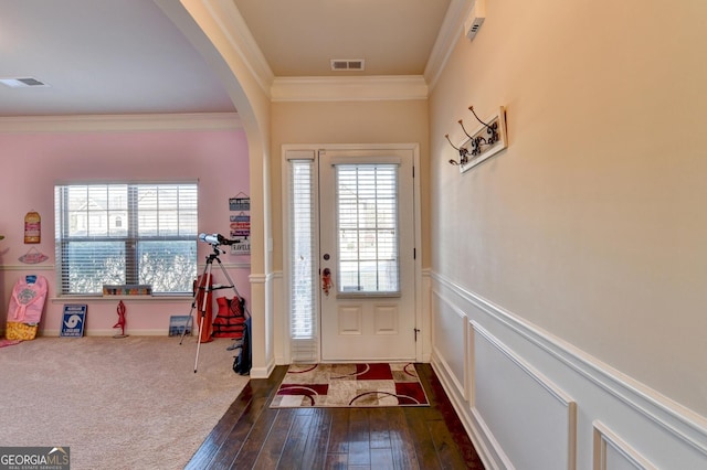 doorway to outside with dark hardwood / wood-style flooring and ornamental molding