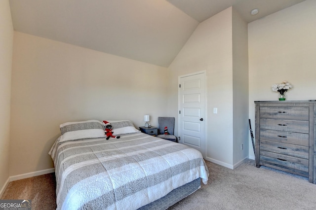 carpeted bedroom featuring vaulted ceiling