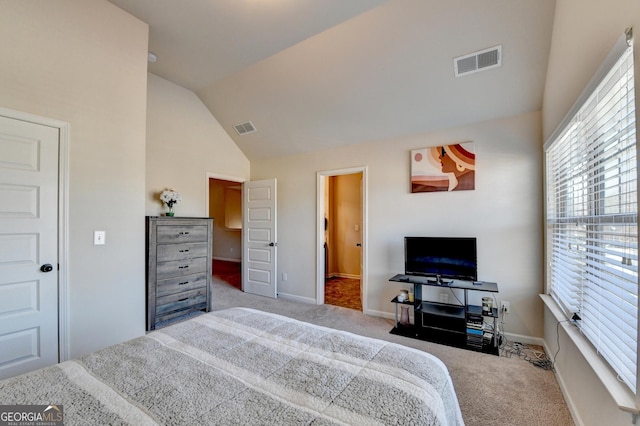 bedroom featuring light carpet and vaulted ceiling