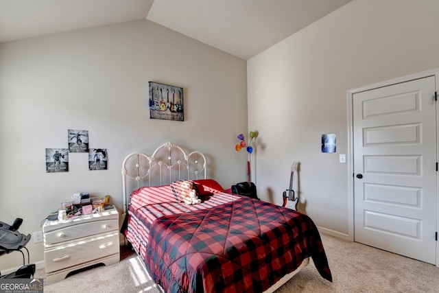 bedroom featuring carpet floors and vaulted ceiling