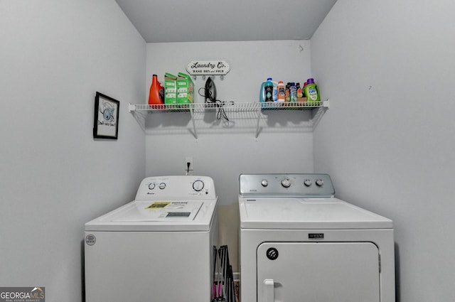 washroom with washing machine and clothes dryer