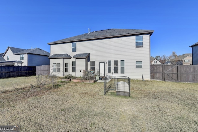 rear view of property with a yard