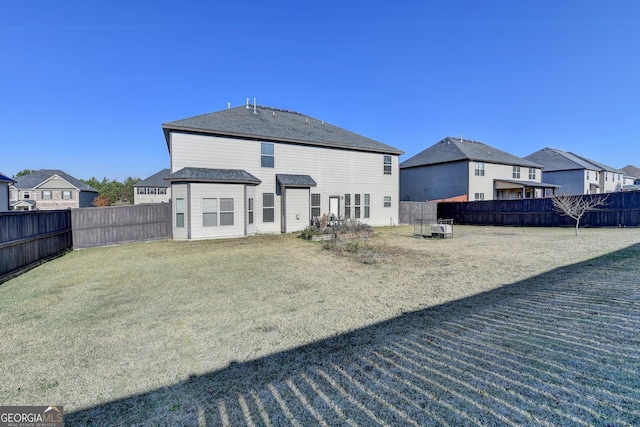 rear view of property featuring a lawn