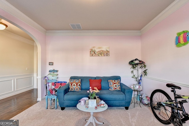 living room featuring wood-type flooring and ornamental molding