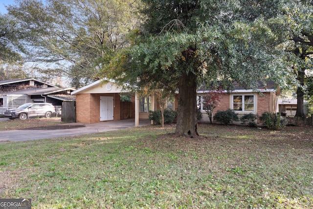 view of front facade with a front yard and a carport