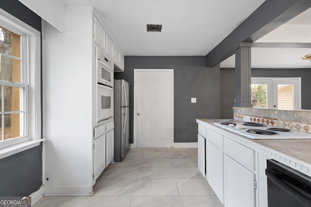 kitchen with white cabinetry and white appliances