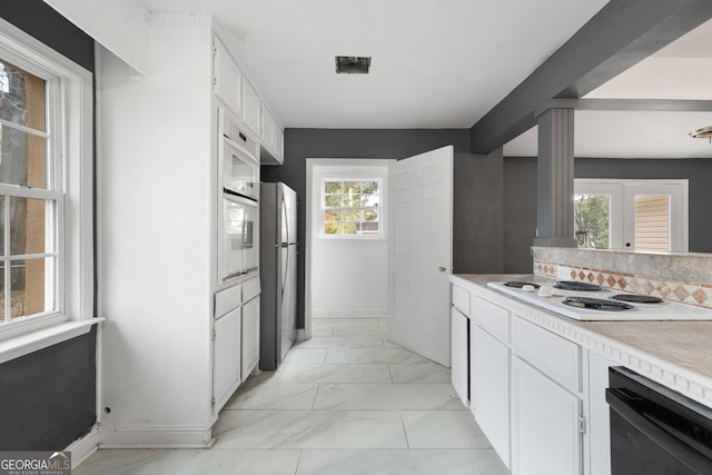 kitchen with white cabinetry, french doors, and white appliances