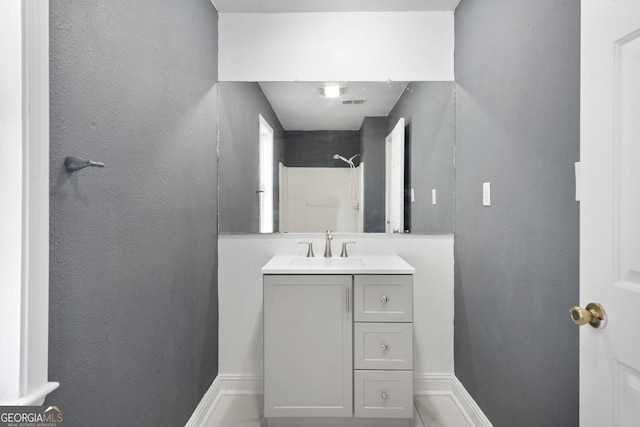 bathroom with a shower and vanity