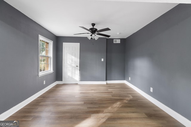 spare room with ceiling fan and wood-type flooring