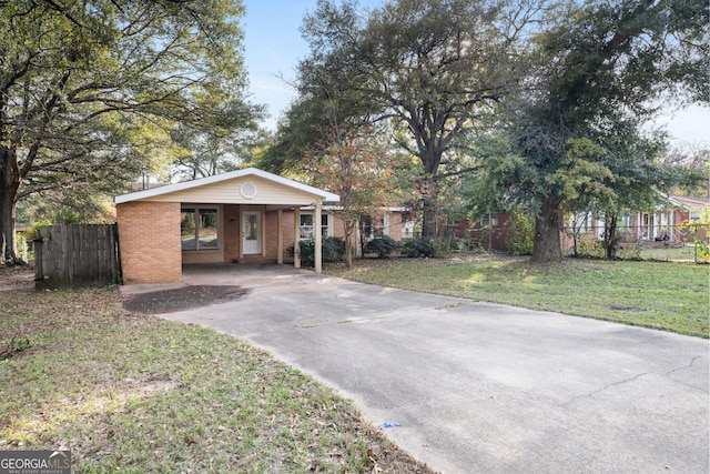 view of front of house with a front lawn and a carport