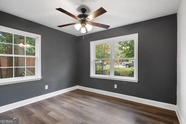 unfurnished room featuring ceiling fan, a healthy amount of sunlight, and wood-type flooring