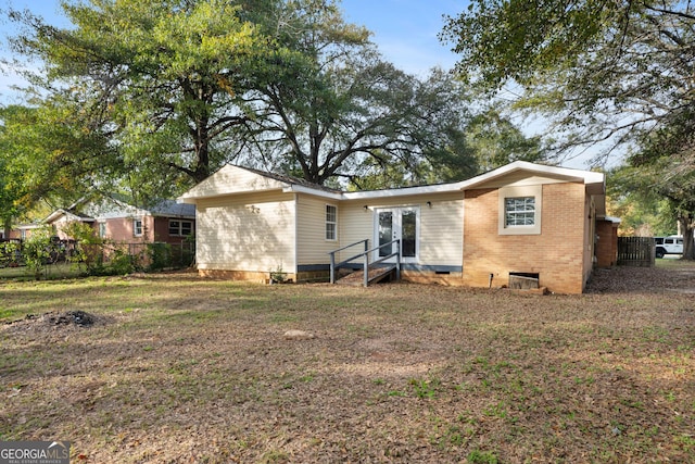 rear view of house featuring french doors