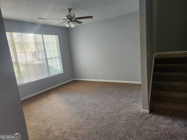 unfurnished room with carpet flooring, a textured ceiling, and ceiling fan